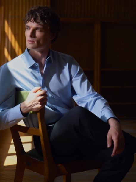 Dwa zdjęcia, mężczyzna siedzący na krześle w formalnej błękitnej koszuli